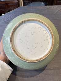 A Chinese monochrome celadon-glazed jar with anhua chilong and floral design, Kangxi