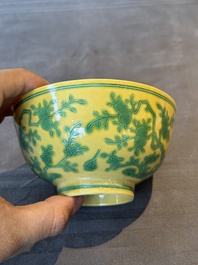 A pair of Chinese yellow-ground 'peach and bird' bowls, Qianlong mark and probably of the period