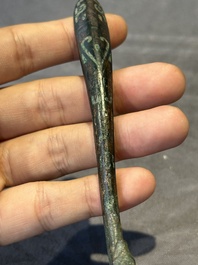 A varied collection of six Chinese bronze belt hooks, Warring States period and Western Han