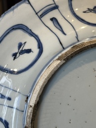 A Chinese blue and white kraak porcelain dish with flowers in a jardiniere, Wanli