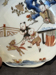 A Chinese polychrome cup and saucer with figures and a dog, Yongzheng