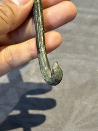 A varied collection of six Chinese bronze belt hooks, Warring States period and Western Han