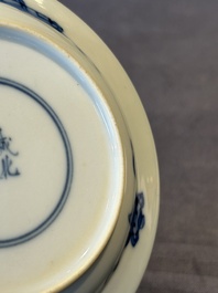 A Chinese blue and white 'erotic' cup and saucer, Kangxi
