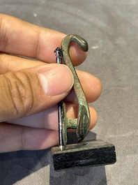A varied collection of six Chinese bronze belt hooks, Warring States period and Western Han