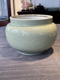 A Chinese monochrome celadon-glazed jar with anhua chilong and floral design, Kangxi