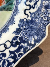 A Chinese famille rose 'He Xiangu' charger with a blue and white border, Qianlong
