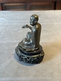 A small Chinese bronze figure of a Luohan, Ming