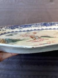 A Chinese famille rose 'He Xiangu' charger with a blue and white border, Qianlong