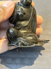 A small Chinese bronze figure of a Luohan, Ming