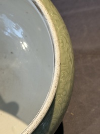 A Chinese monochrome celadon-glazed jar with anhua chilong and floral design, Kangxi