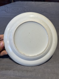 A pair of Chinese Canton famille rose plates with figures in a garden, 19th C.