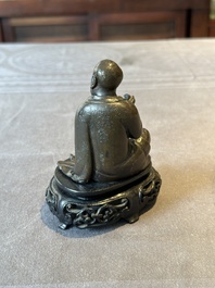 A small Chinese bronze figure of a Luohan, Ming