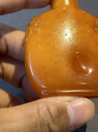 A rare Chinese amber lion-handled snuff bottle, 19th C.