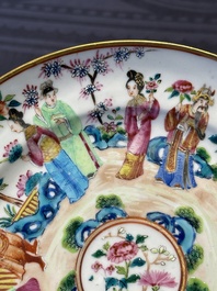 A pair of Chinese Canton famille rose plates with figures in a garden, 19th C.