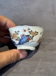 A Chinese polychrome cup and saucer with figures and a dog, Yongzheng