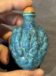 A rare Chinese robin's-egg-glazed moulded '18 Luohan' snuff bottle, 19th C.