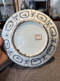 A Chinese blue and white kraak porcelain dish with flowers in a jardiniere, Wanli