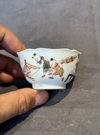 A Chinese polychrome cup and saucer with figures and a dog, Yongzheng
