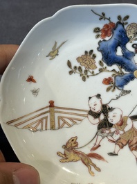 A Chinese polychrome cup and saucer with figures and a dog, Yongzheng