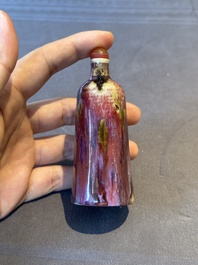 Two Chinese famille rose 'lotus scroll' snuff bottles and a flamb&eacute;-glazed snuff bottle, 19th C.