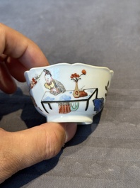 A Chinese polychrome cup and saucer with figures and a dog, Yongzheng