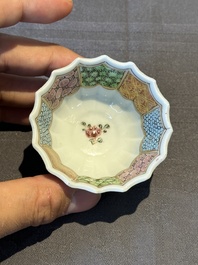 A Chinese famille rose cup and saucer with a reclined lady, Qianlong