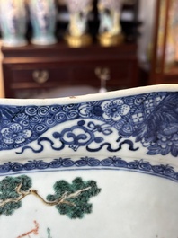 A Chinese famille rose 'He Xiangu' charger with a blue and white border, Qianlong