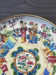A pair of Chinese Canton famille rose plates with figures in a garden, 19th C.