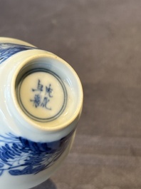 A Chinese blue and white 'erotic' cup and saucer, Kangxi