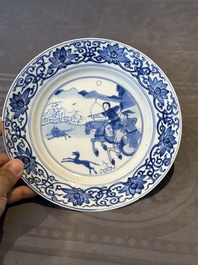 A pair of Chinese blue and white 'hunting scene' plates, Qi Yu Bao Ding Zhi Zhen 奇玉寶鼎之珍 mark, Kangxi