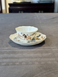 A Chinese polychrome cup and saucer with figures and a dog, Yongzheng