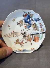 A Chinese polychrome cup and saucer with figures and a dog, Yongzheng