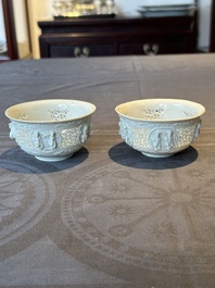 A pair of rare Chinese reticulated white-glazed biscuit 'Eight Immortals and Shoulao' bowls, Wanli