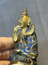 A Chinese gilt and champlev&eacute; enamelled bronze Bodhisattva on a carved stone stand, Qing