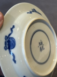 A Chinese blue and white 'erotic' cup and saucer, Kangxi