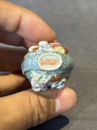 A Chinese moulded famille rose 'playing boys' snuff bottle, Qianlong mark, 19th C.