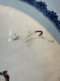 A Chinese famille rose 'He Xiangu' charger with a blue and white border, Qianlong