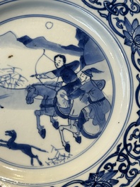 A pair of Chinese blue and white 'hunting scene' plates, Qi Yu Bao Ding Zhi Zhen 奇玉寶鼎之珍 mark, Kangxi