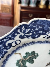A Chinese famille rose 'He Xiangu' charger with a blue and white border, Qianlong