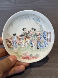 A Chinese famille rose cup and saucer with music making ladies, Yongzheng/Qianlong
