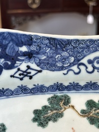 A Chinese famille rose 'He Xiangu' charger with a blue and white border, Qianlong