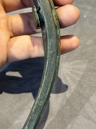 A varied collection of six Chinese bronze belt hooks, Warring States period and Western Han