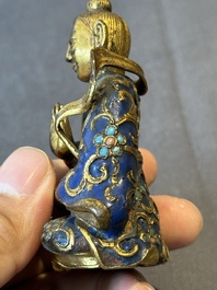 A Chinese gilt and champlev&eacute; enamelled bronze Bodhisattva on a carved stone stand, Qing