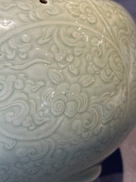 A Chinese monochrome celadon-glazed jar with anhua chilong and floral design, Kangxi