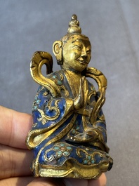 A Chinese gilt and champlev&eacute; enamelled bronze Bodhisattva on a carved stone stand, Qing
