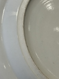 A pair of Chinese Canton famille rose plates with figures in a garden, 19th C.