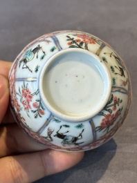 A Chinese famille rose cup and saucer with figures and animals, Yongzheng