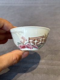 A Chinese famille rose cup and saucer with music making ladies, Yongzheng/Qianlong