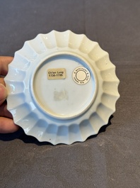 A Chinese famille rose cup and saucer with a reclined lady, Qianlong