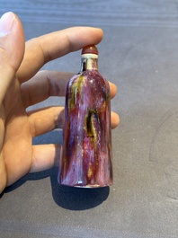 Two Chinese famille rose 'lotus scroll' snuff bottles and a flamb&eacute;-glazed snuff bottle, 19th C.